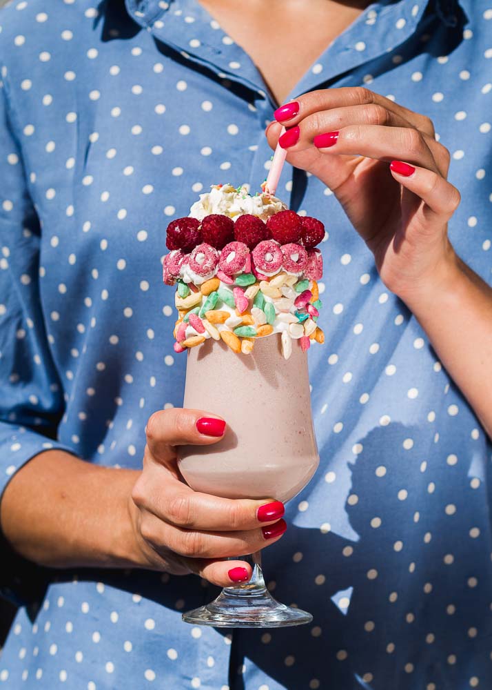 front view woman holding milkshake